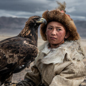 Arkalak, a twelve-year-old eagle hunter, holds his eagle in the Altai mountains of western Mongolia. Following in his father’s footsteps and in keeping with Kazakh eagle hunting tradition, Arkalak started training his own eagle at the age of ten.